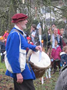 man in mediaeval costume leading the Wassail at Avoncroft with a drum