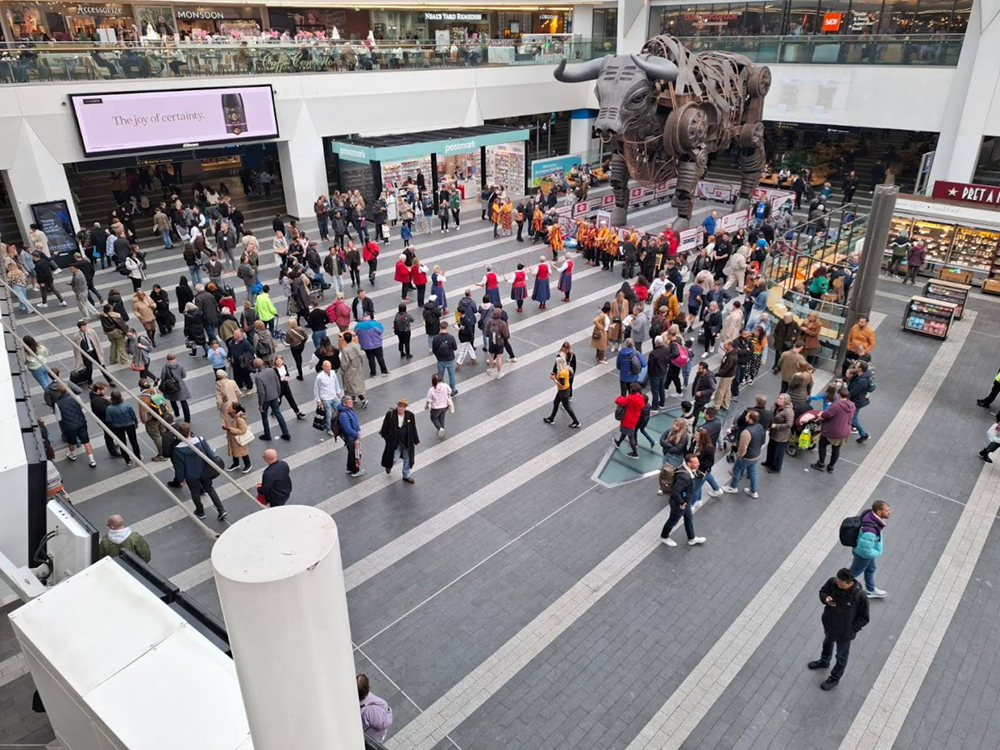 general view of Nancy Butterfly dancing in the concourse at New Street Station Birmingham amongst crowds of travellers