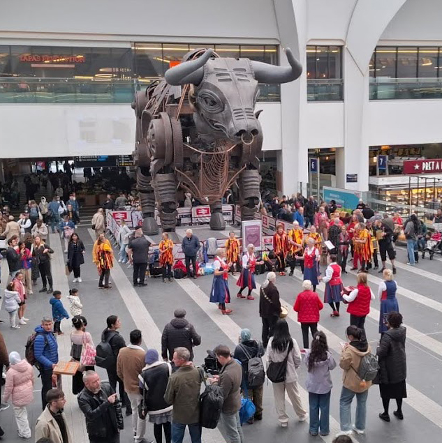 closer view of Butterflies dancing in front of the enormous Commonwealth Games Bull