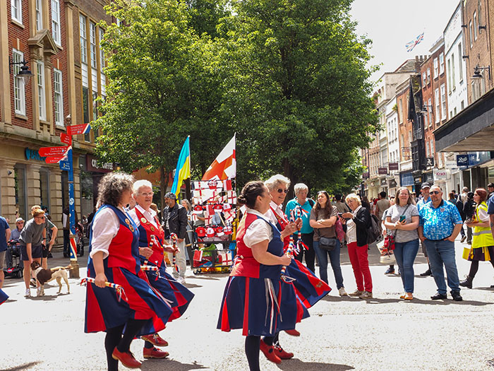 dancing in the high street Worcester in front of a good audience and flags on sale ready for the Euros