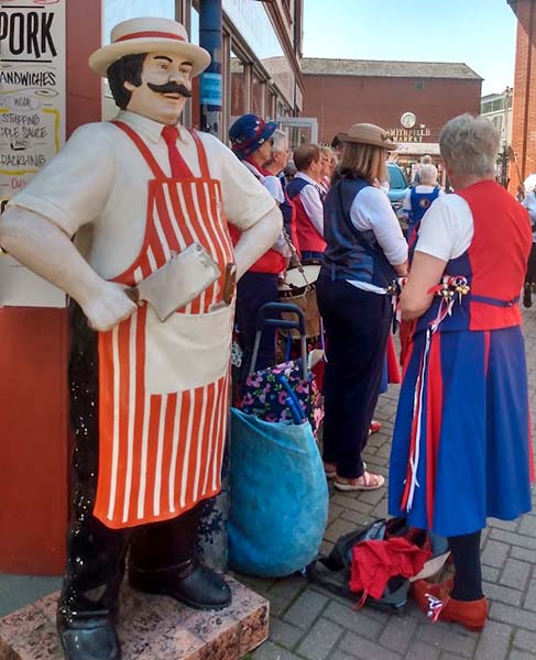 A butcher's mannequin standing outside the shop