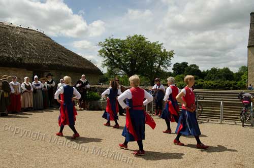 Dancing at Coggs Manor Farm Witney in front of impressive thatched building