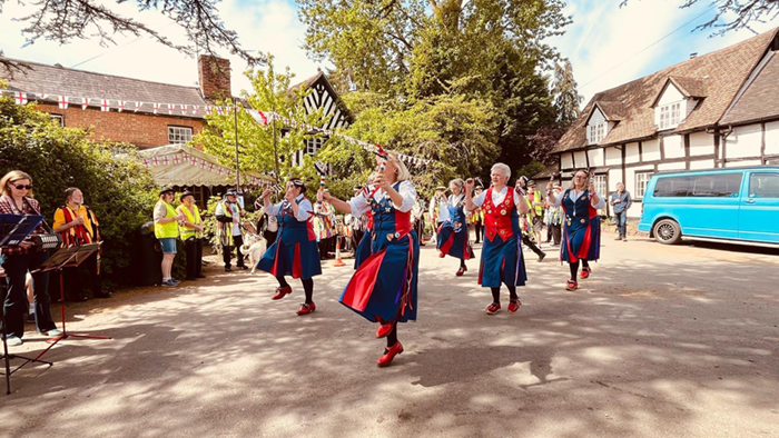 Nancy Butterfly dancing in front of the traditional English pub the 3Kings in Hanley Castle