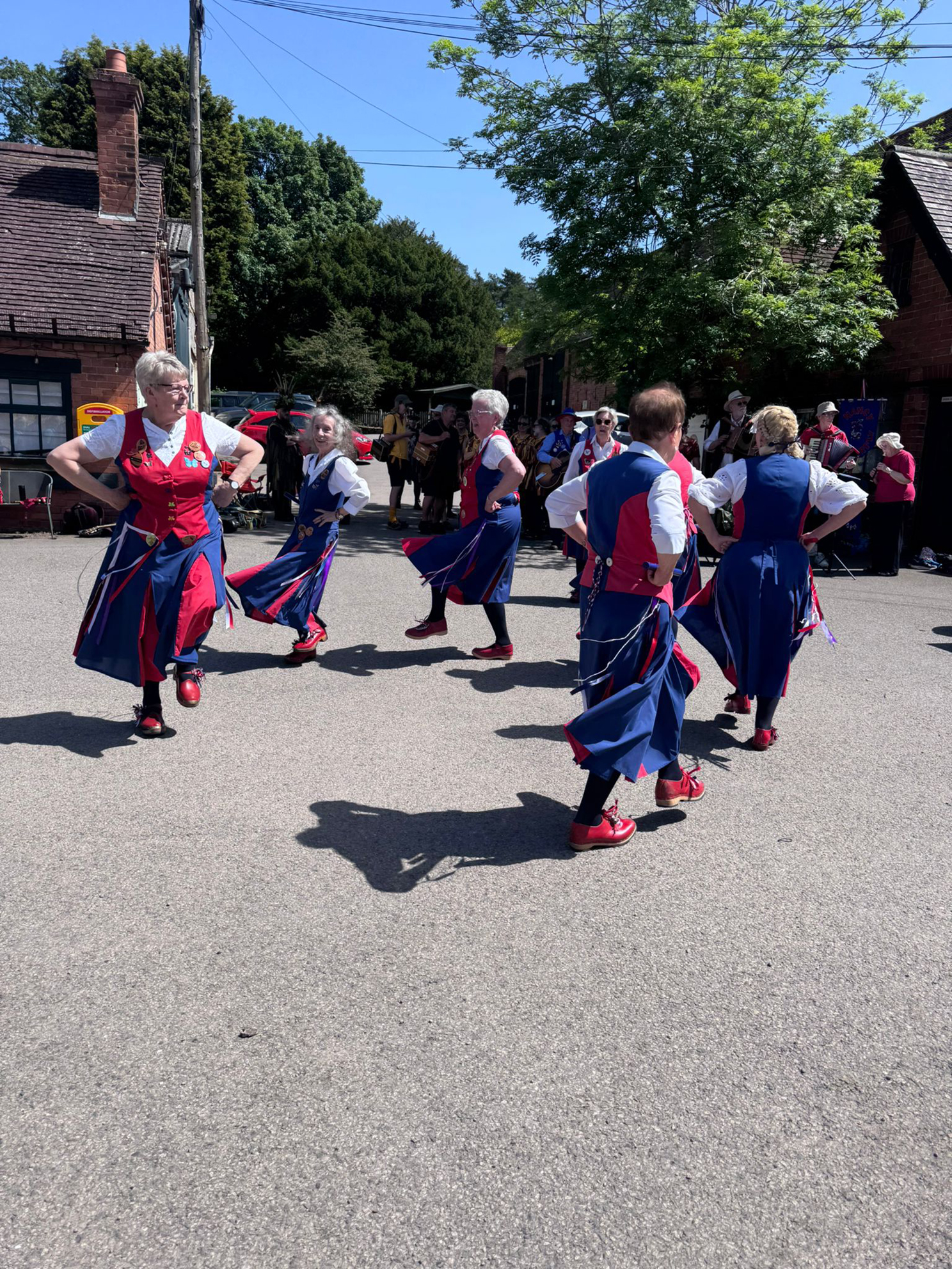 Butterfly dancers in action forming a circle, hands on hips